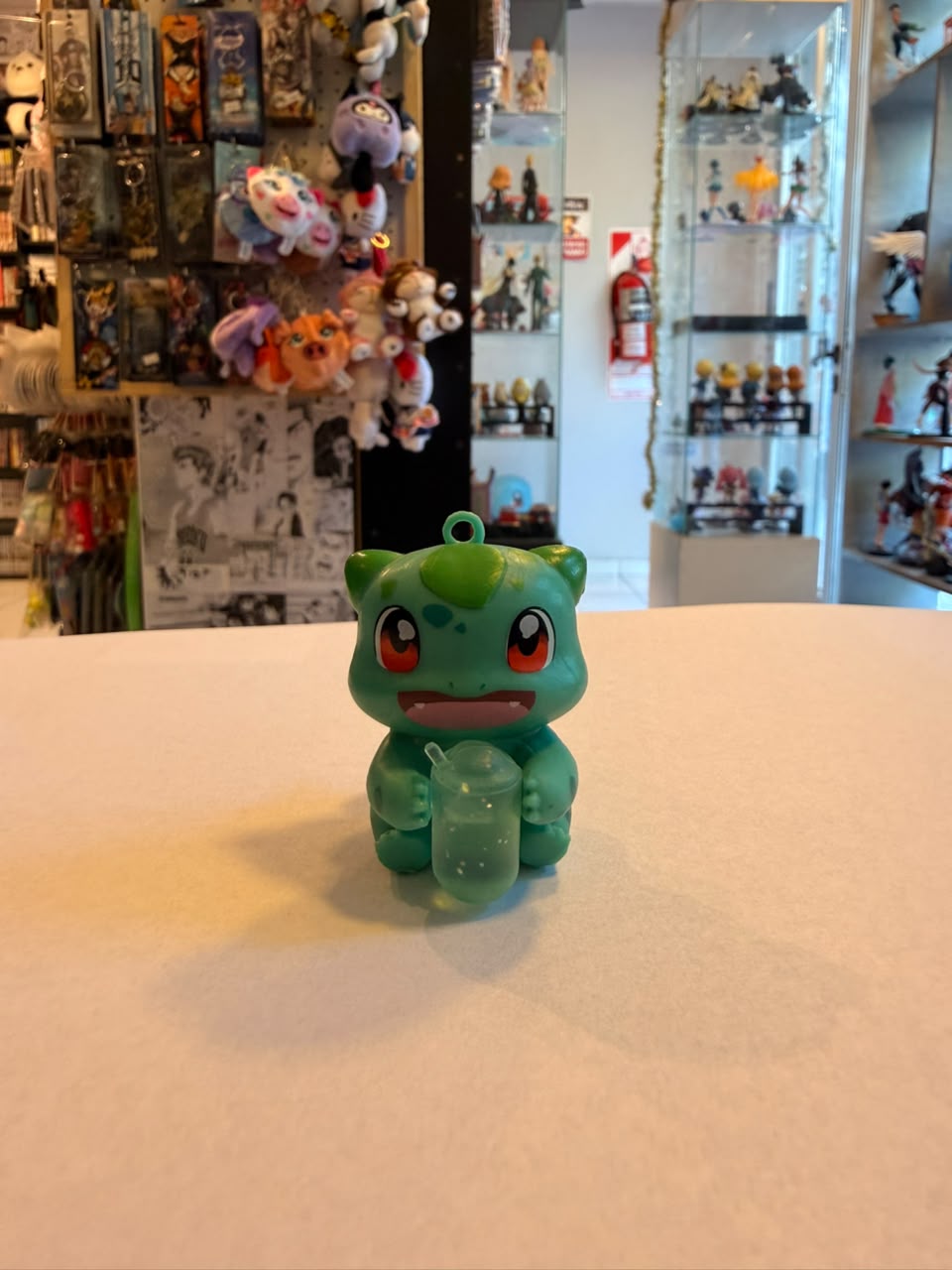 FIGURA GASHAPON DE BULBASAUR SOSTENIENDO BEBIDA