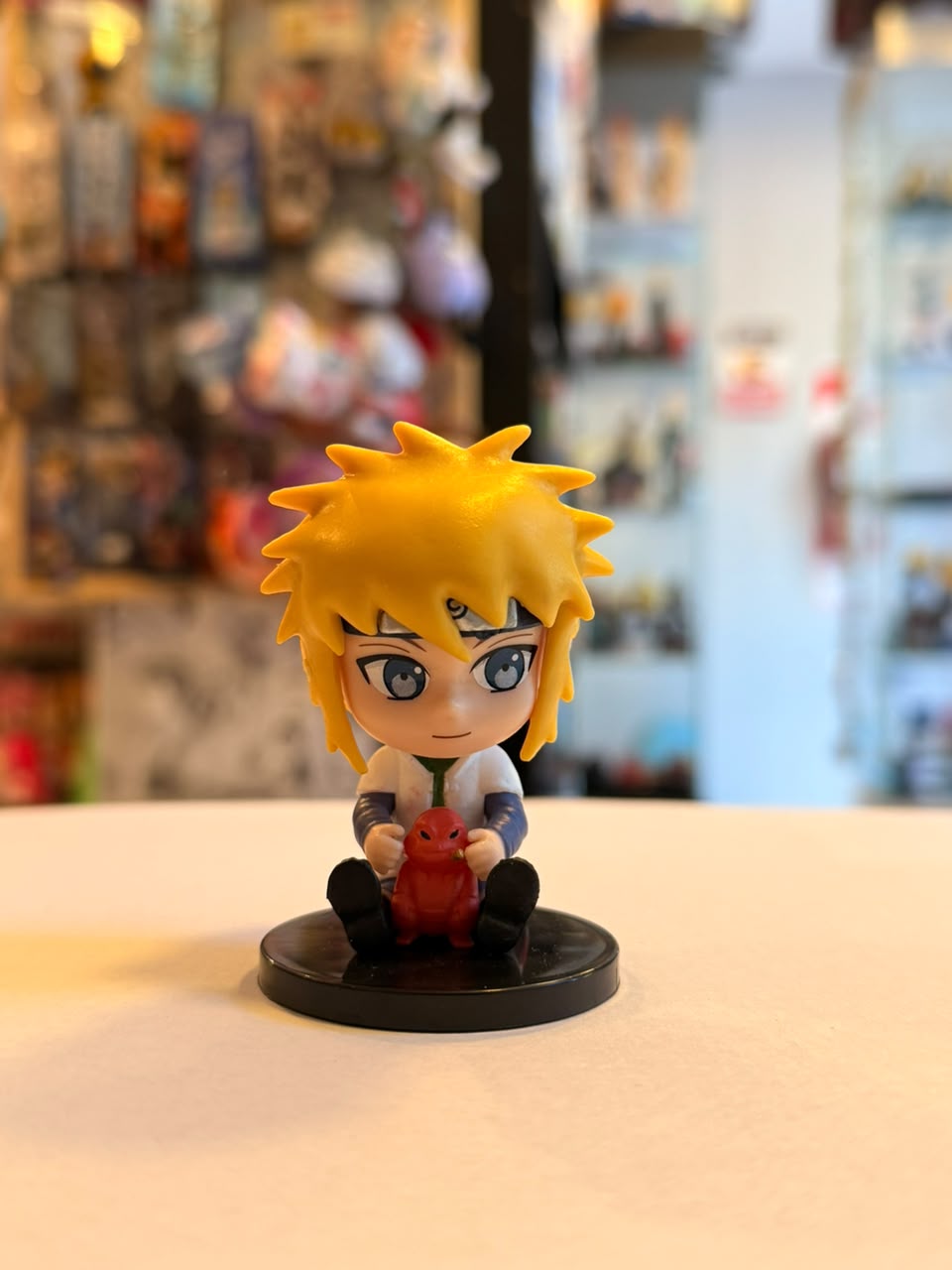 FIGURA GASHAPON DE MINATO SENTADO JUNTO A GAMA-CHAN