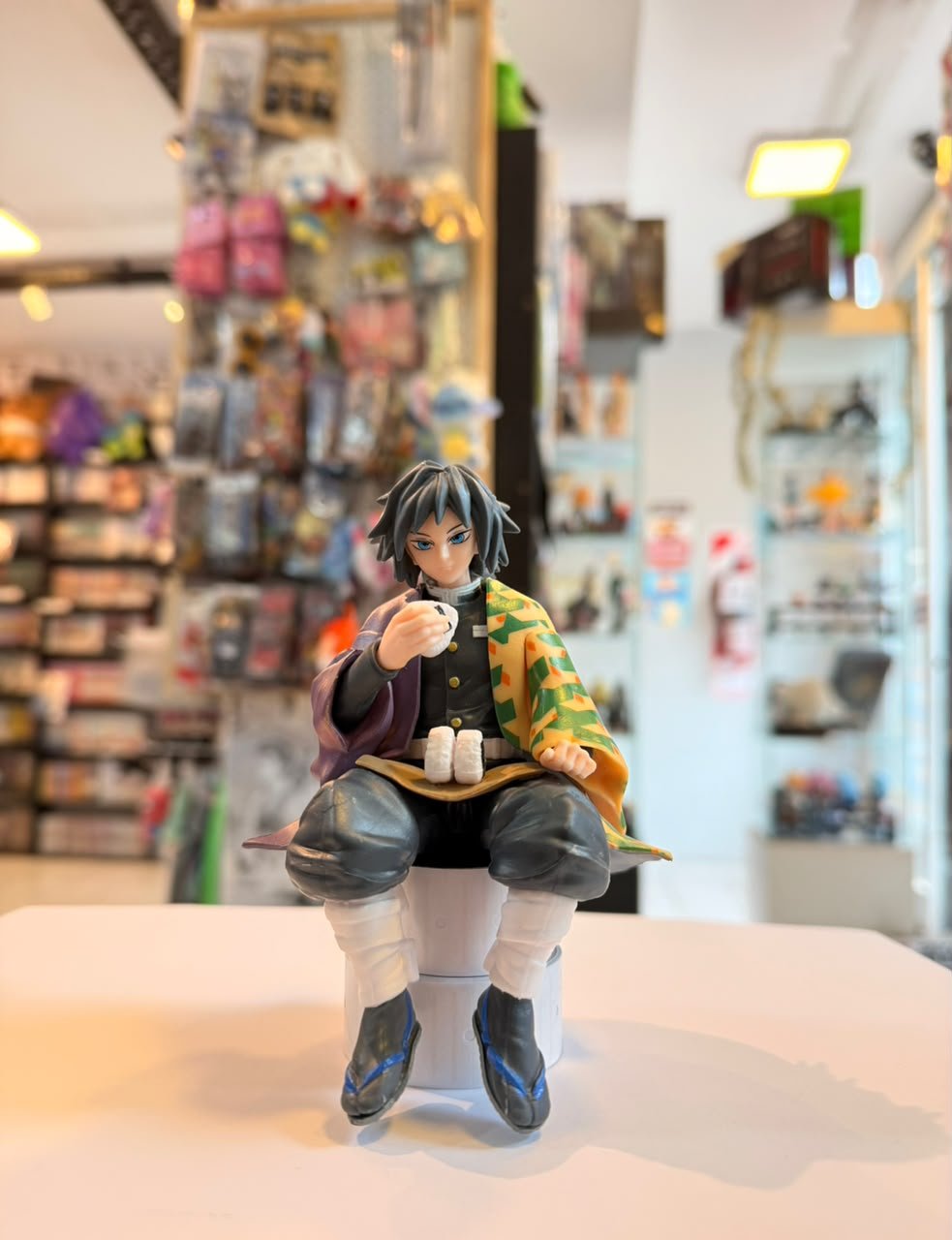 FIGURA DE TOMIOKA SENTADO COMIENDO ONIGIRI